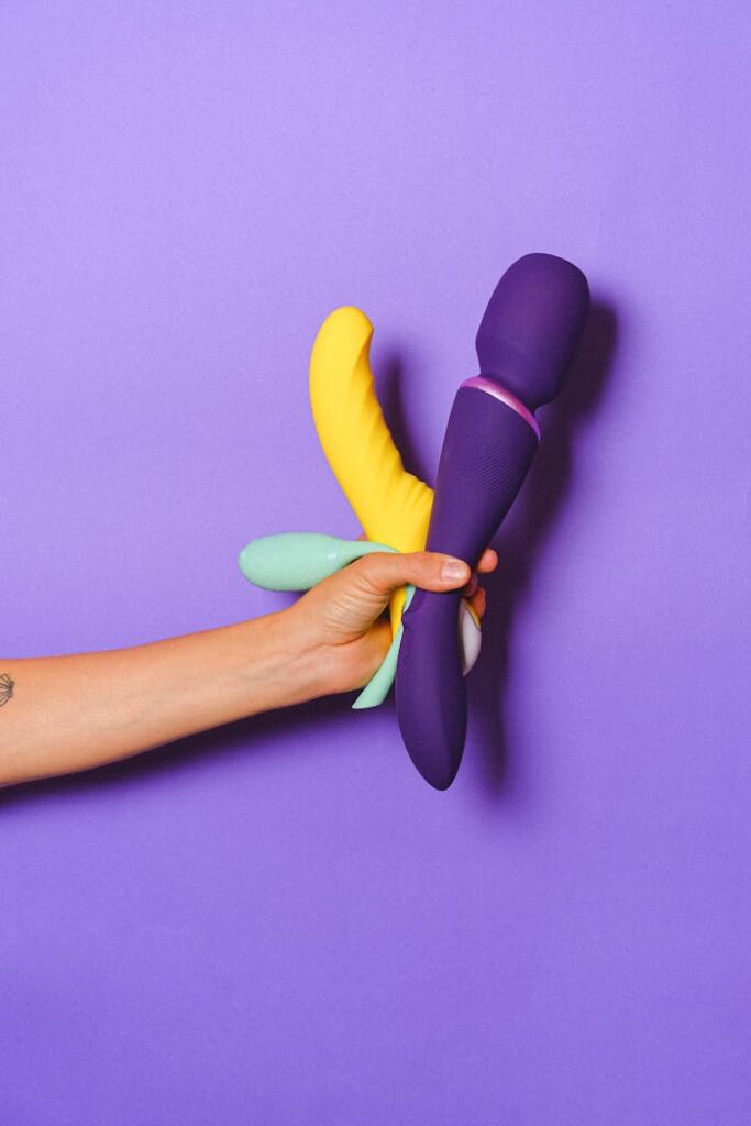 pexels-photo-5187575 Colorful silicone sex toys against a purple background for sexual wellness and education.